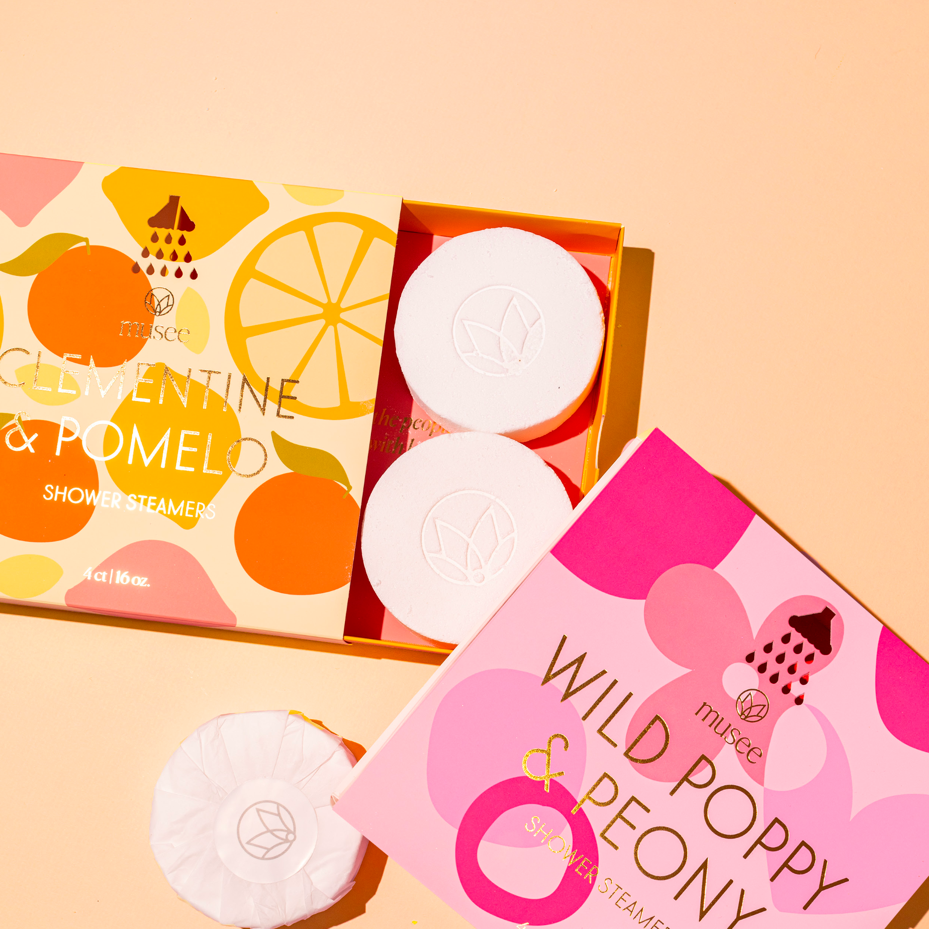 Shower steamers with Clementine & Pomelo packaging on a white background