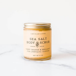 Jar of sea salt body scrub on a white background