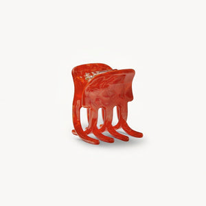 Red hair clip on a white background