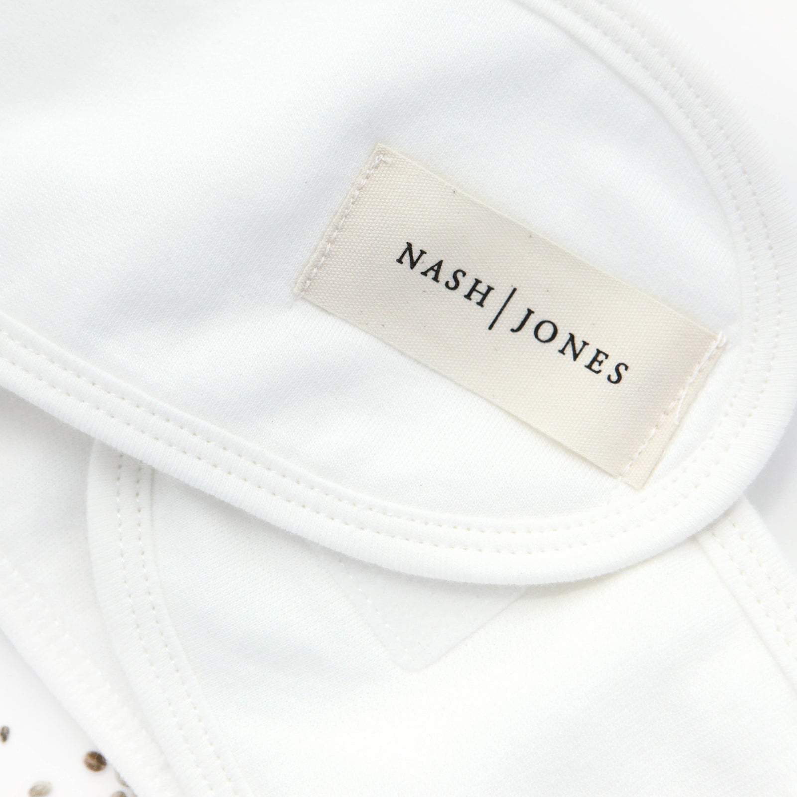 White headbands with 'Nash Jones' branding on packaging and labels.