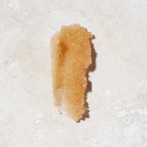 Brown larva on a white textured surface