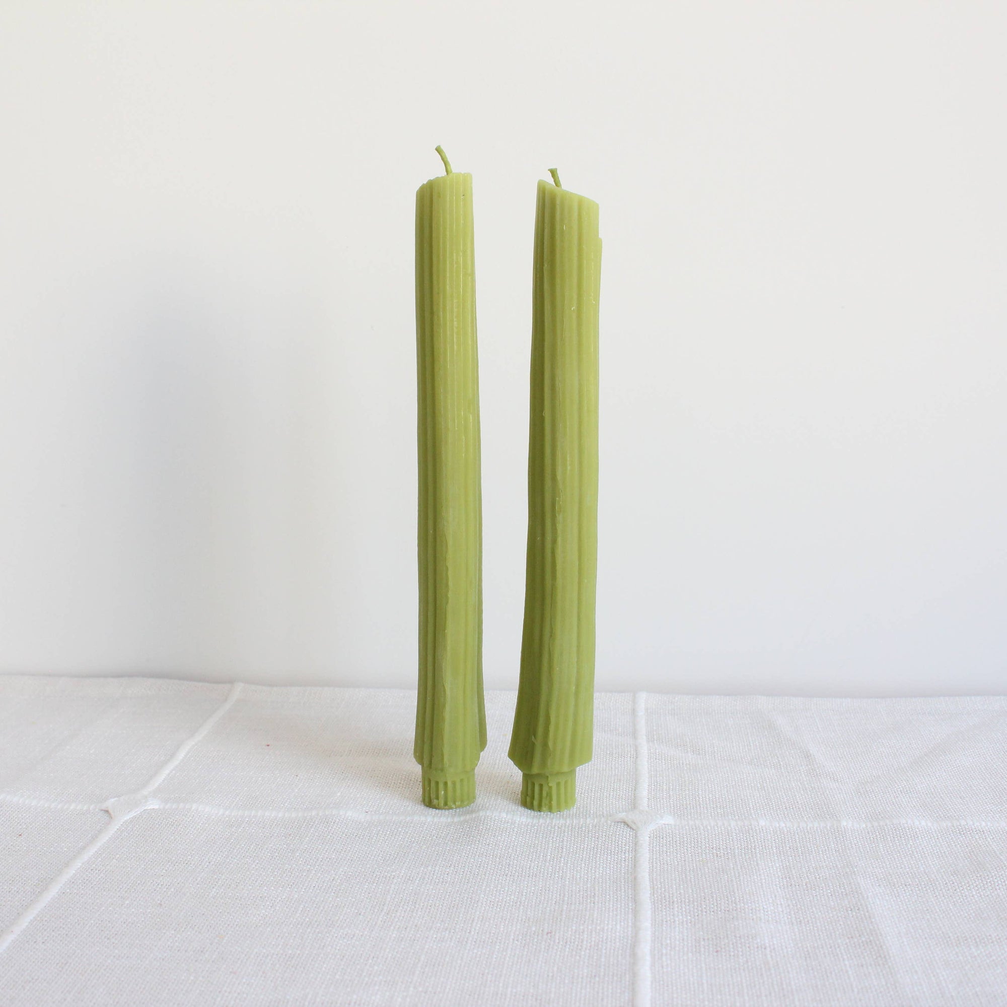 Set of green candles with a 'Happy Organics' label on a white background