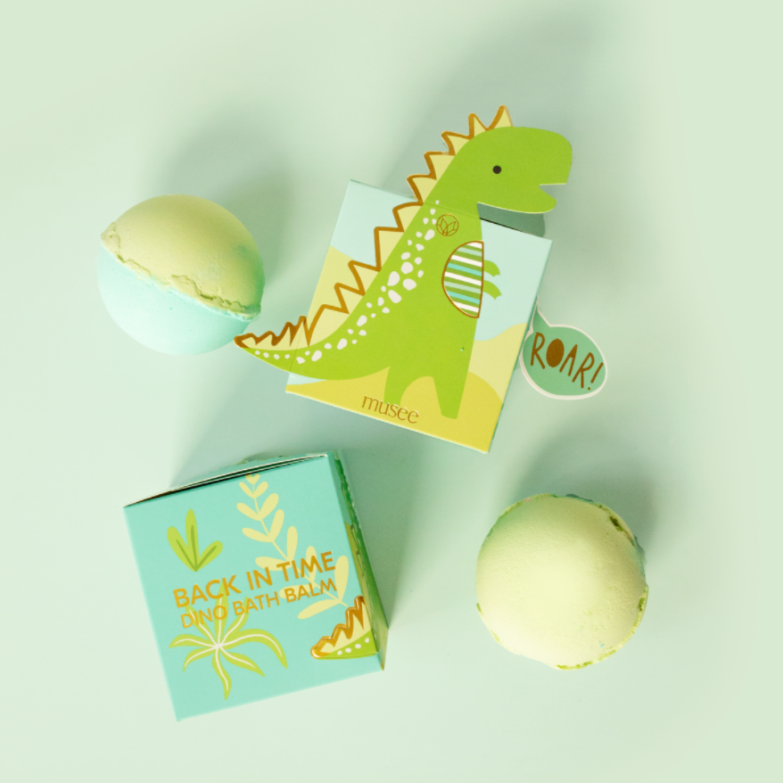 Bath bomb with a dinosaur-themed packaging on a white background