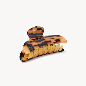 Tortoiseshell patterned hair clip on a white background