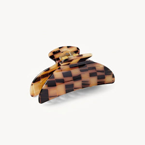 Checkered tortoiseshell hair clip on a white background