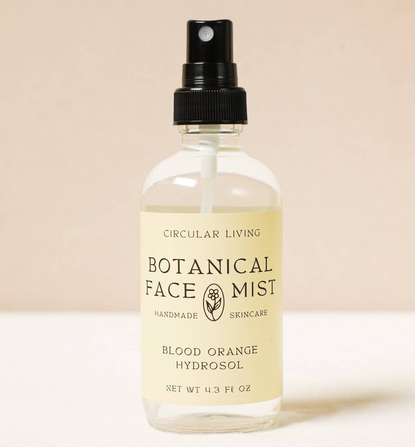 Bottle of Botanical Face Mist with a beige label on a light background