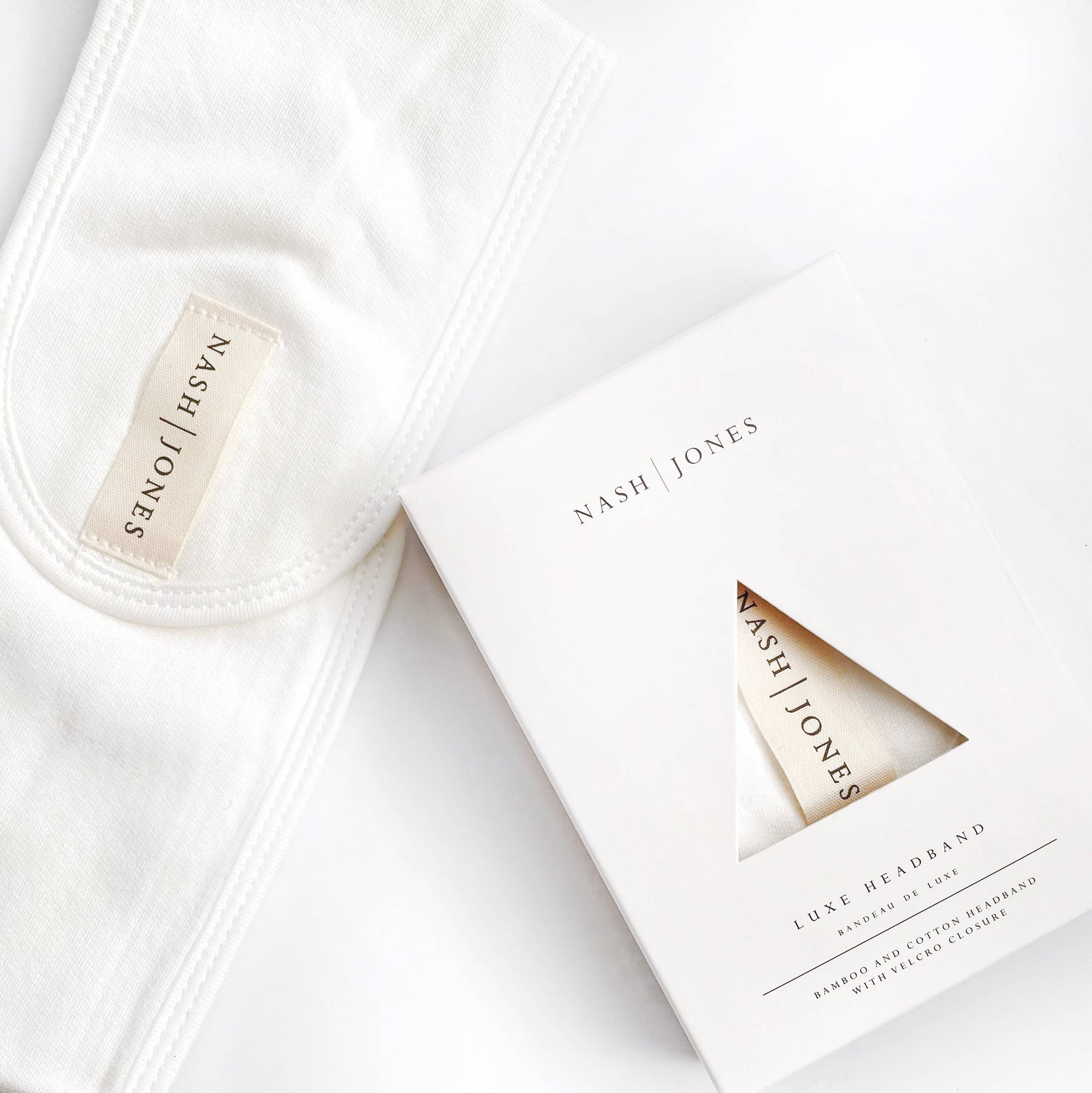 White headbands with 'Nash Jones' branding on packaging and labels.