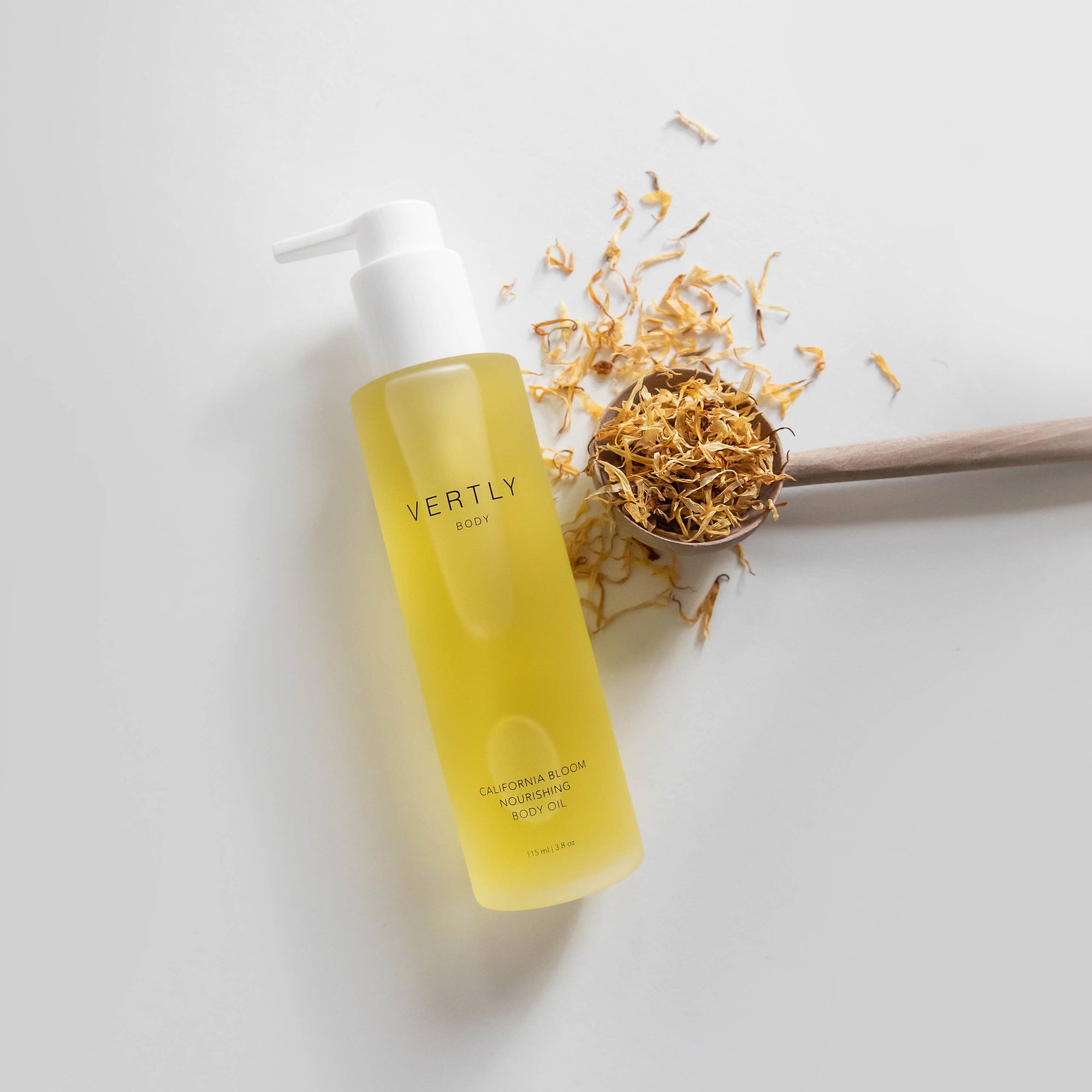 Yellow bottle with white pump and decorative elements on a light gray background