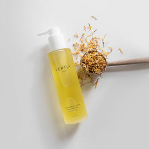 Yellow bottle with white pump and decorative elements on a light gray background