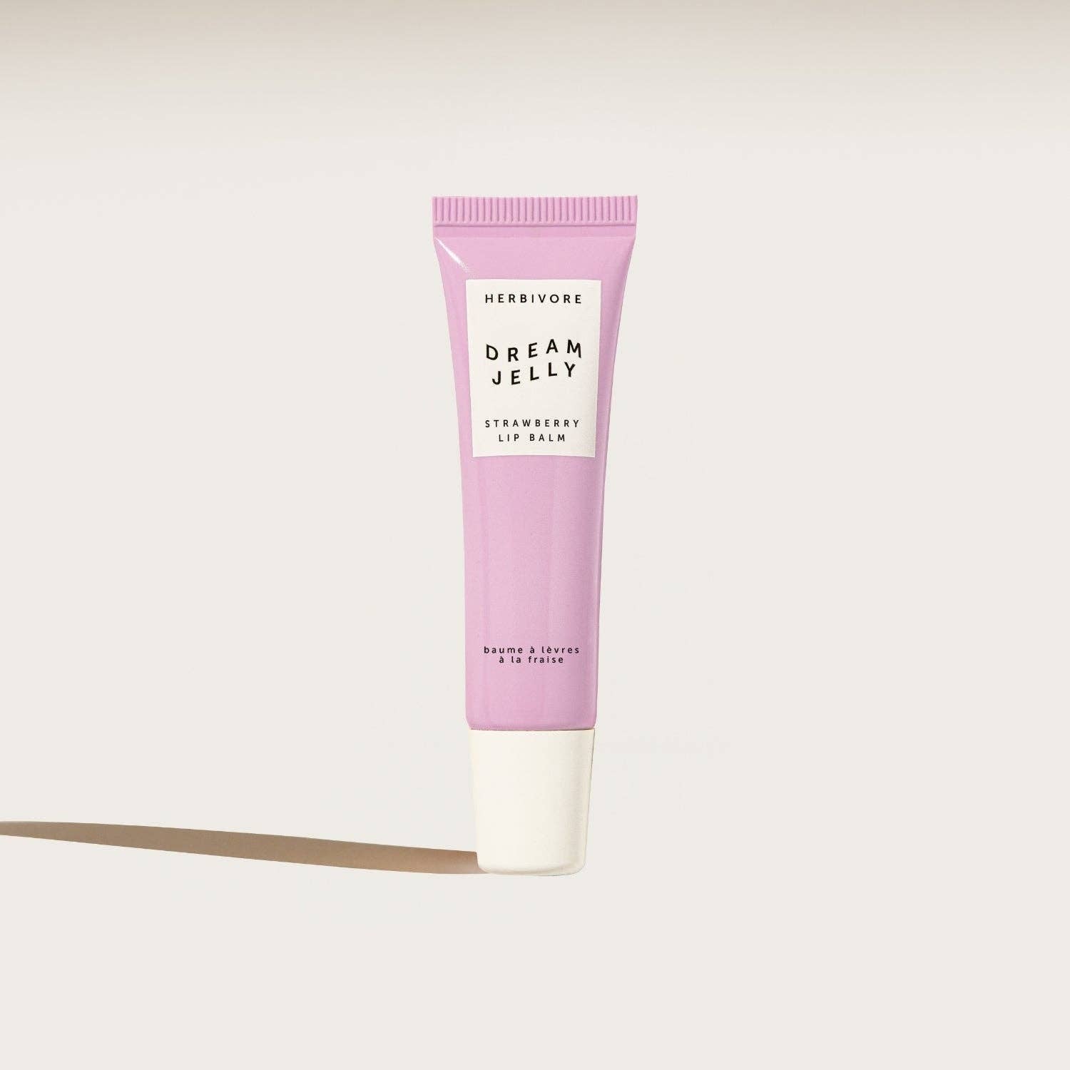 Herbivore Dream Jelly strawberry lip balm on a white background
