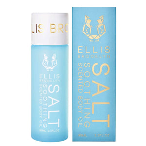 Blue bottle and packaging of Ellis Brooklyn Soothing Body Oil with gold text on a white background