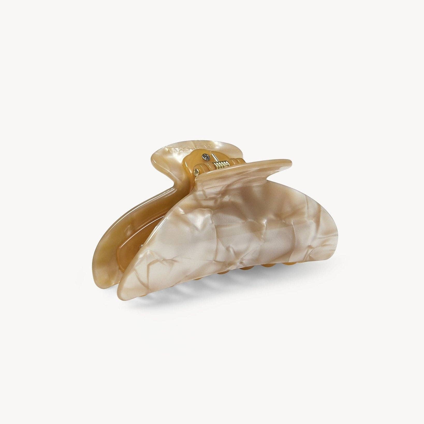 Shell-shaped hair clip on a white background