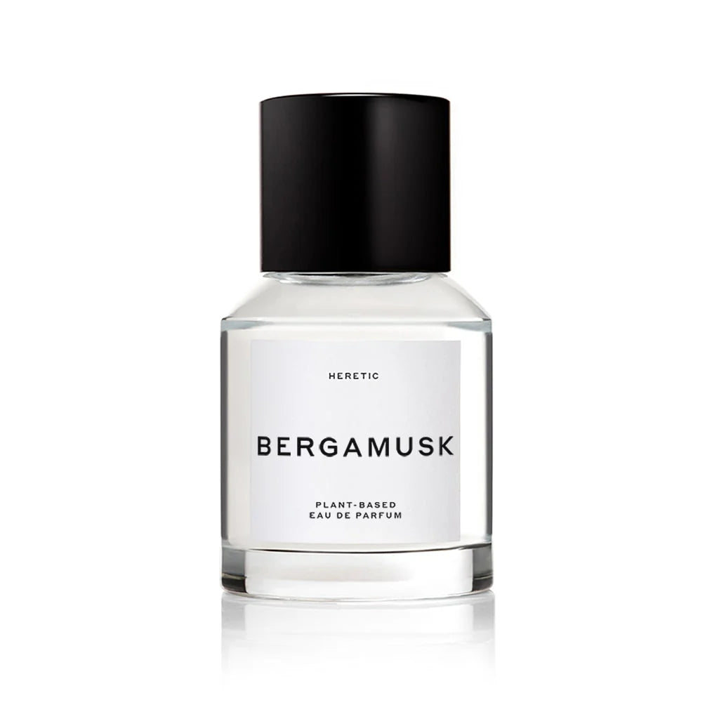 A bottle of Bergamusk perfume, surrounded by limes and greenery. 