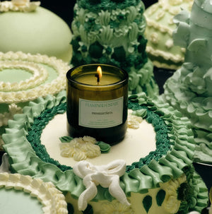 Flamingo Estate limited release Prinsesstarta Candle, surrounded by white and green cakes.
