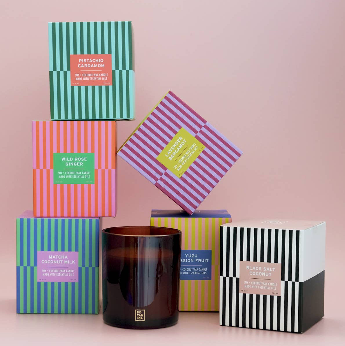 Collection of colorful boxes with candles on a pink background