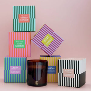 Collection of colorful boxes with candles on a pink background