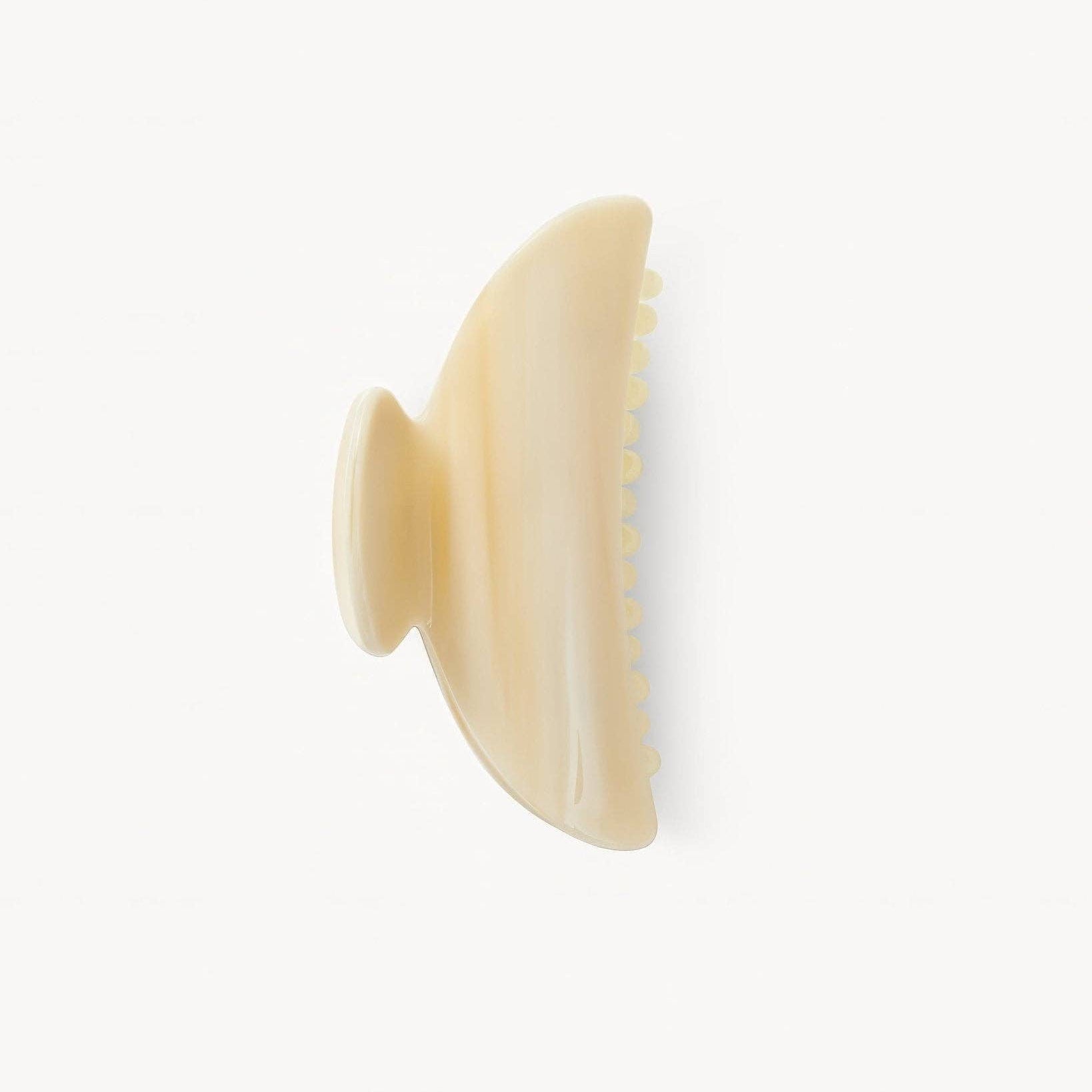 Beige hairbrush on a white background