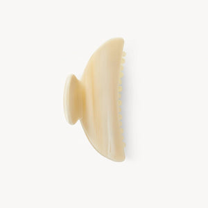 Beige hairbrush on a white background