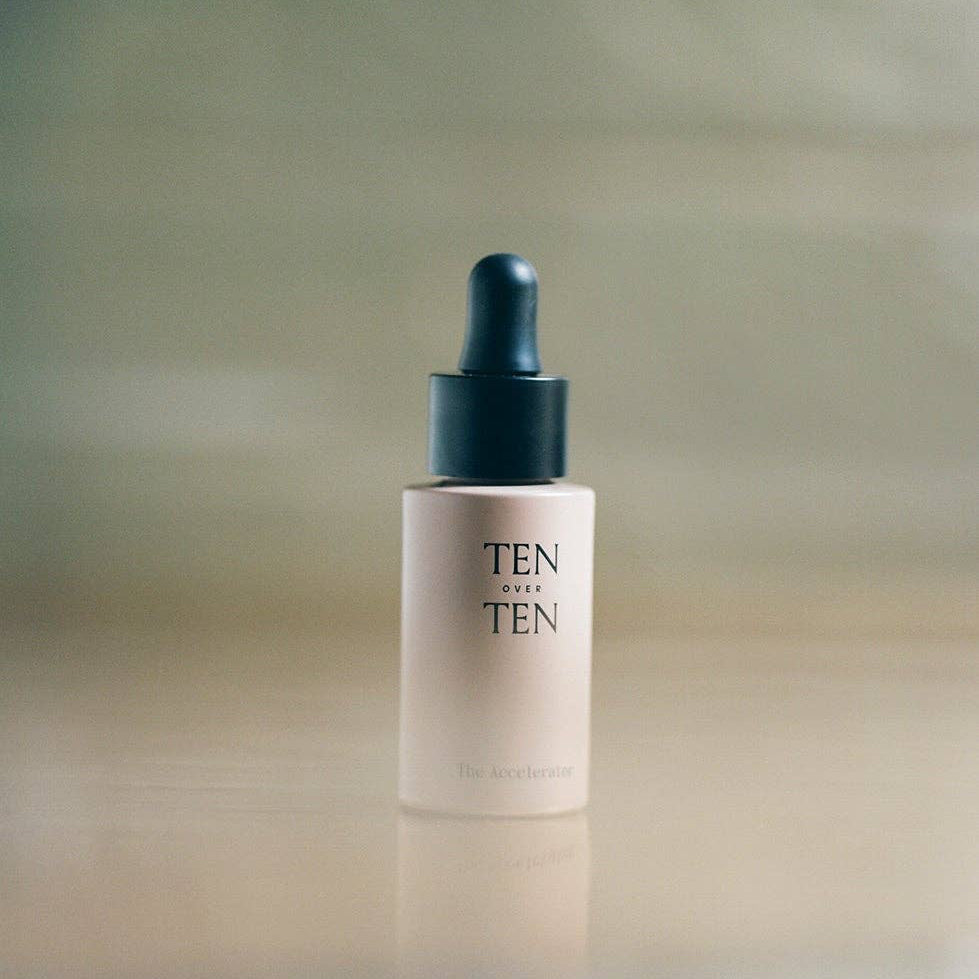 Skincare dropper bottle labeled 'TEN' on a gradient background