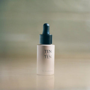 Skincare dropper bottle labeled 'TEN' on a gradient background