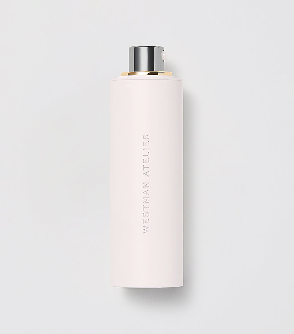 A white cylindrical bottle with a pump dispenser labeled 'SKIN ACTIVATOR SERUM' from Westman Atelier.