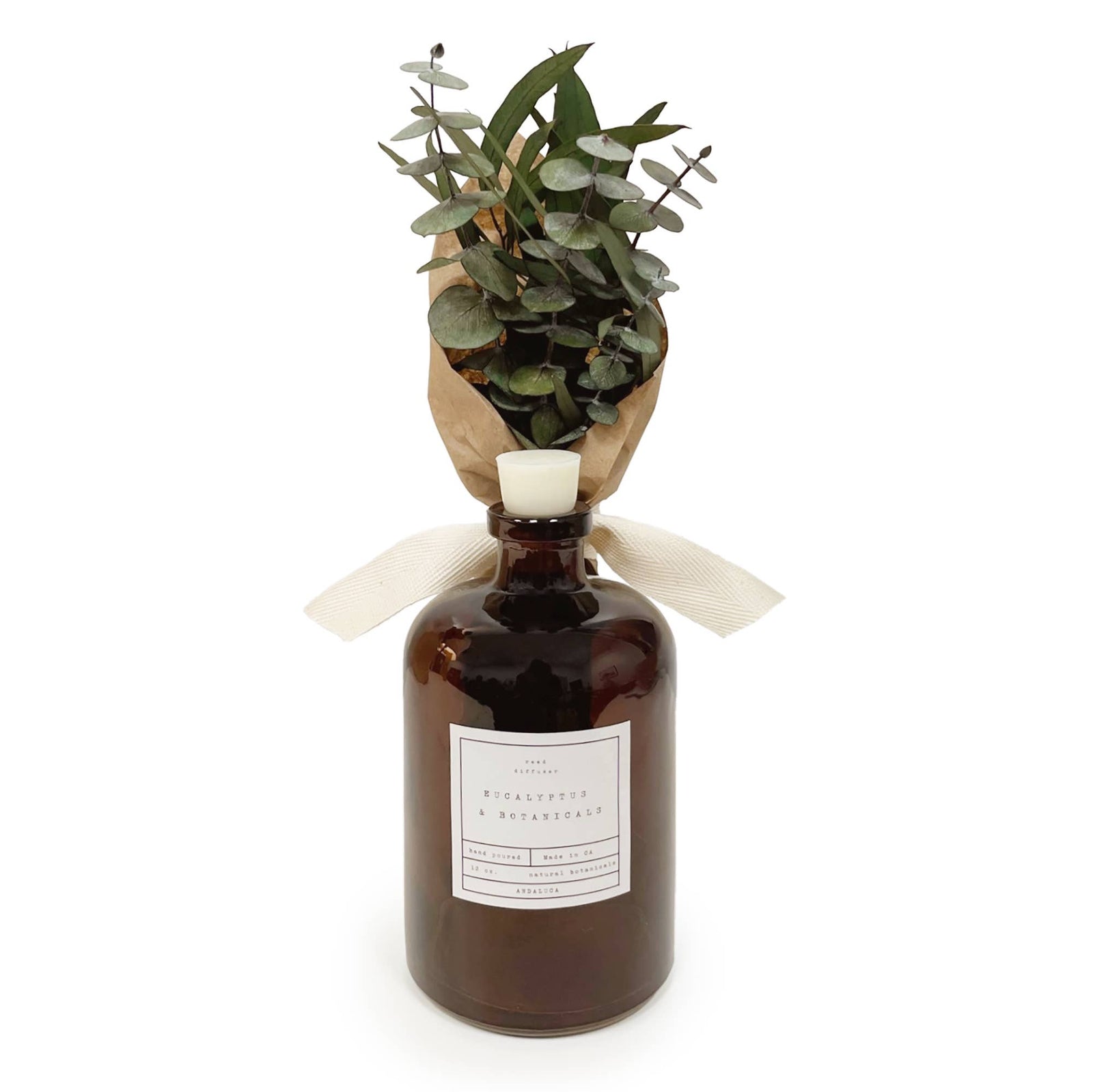 Brown bottle with eucalyptus leaves on a white background