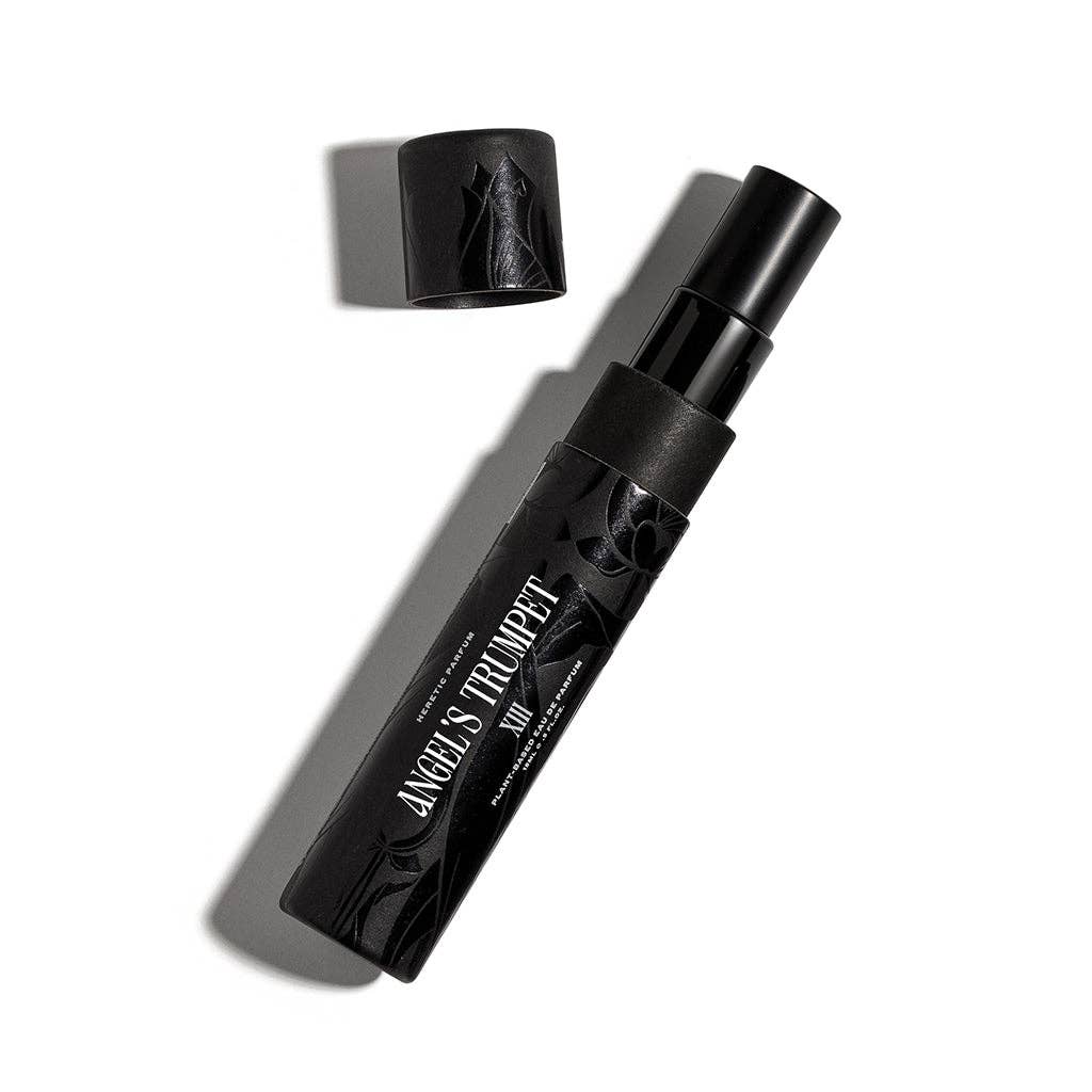 Black cosmetic product with 'Angel's Trumpet' branding on a white background