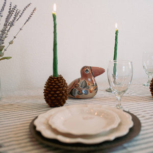 A pair of asparagus taper candles, made by Happy Organics in California