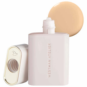Westman Atelier complexion drops bottle with a swatch of beige shade on a white background