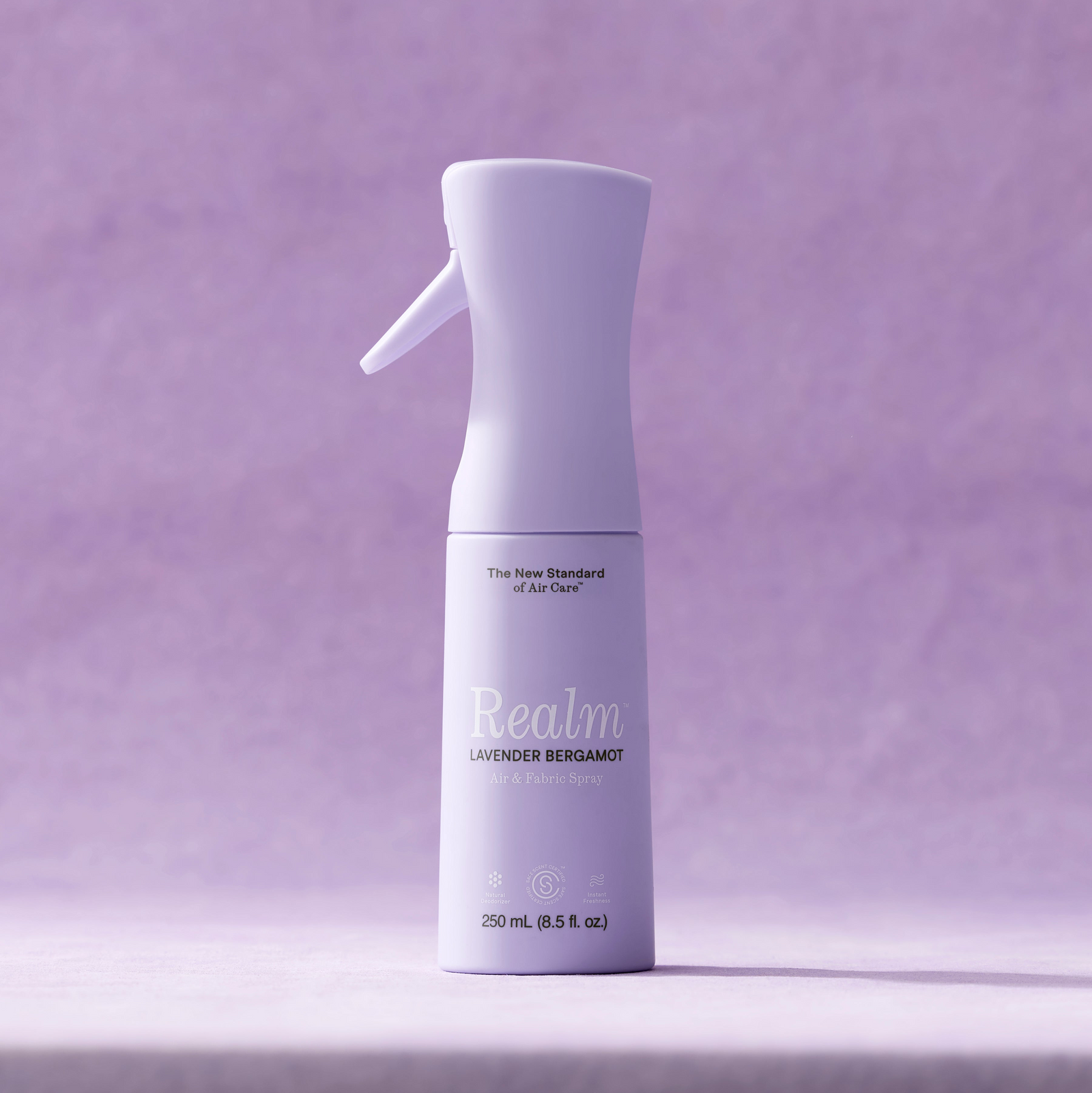 Realm lavender bergamot air freshener bottle on a purple background