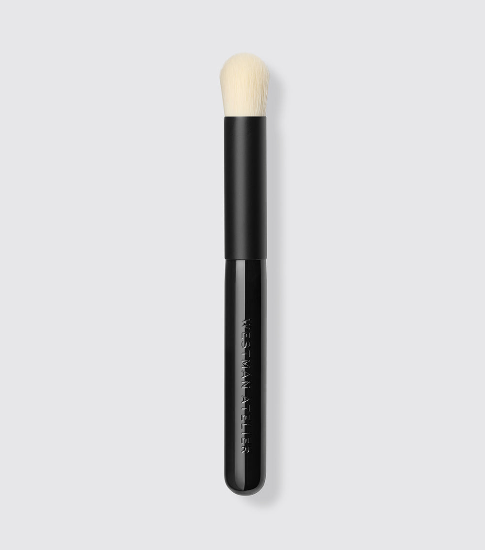 A black and beige Baby Blender Brush with compact bristles for precision blending of cream formulas.