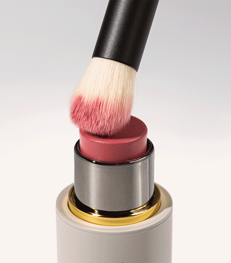 A black and beige Baby Blender Brush with compact bristles for precision blending of cream formulas.