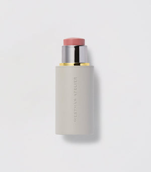 A Baby Cheeks Blush Stick with the cap off, showing a light pink color.