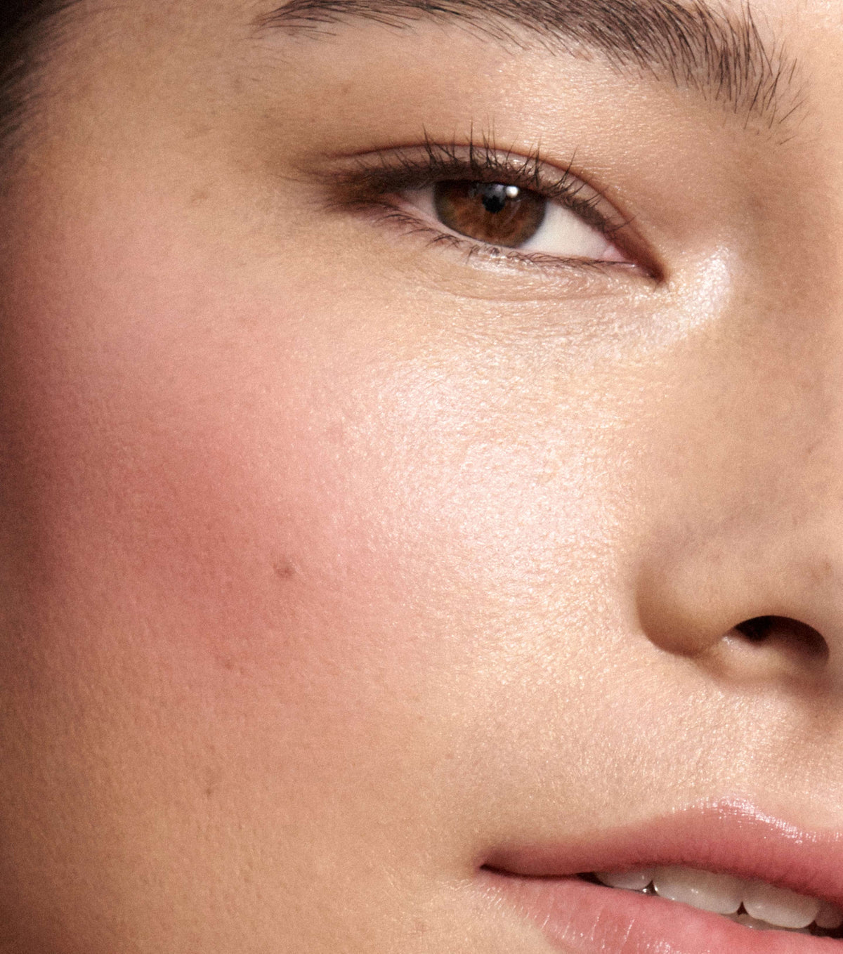 Close-up of a person's eye and nose with a soft focus on skin texture.