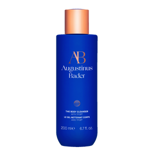 Blue bottle of Augustinus Bader body cleanser on a white background