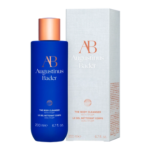 Blue bottle and white box of Augustinus Bader The Body Cleanser on a white background