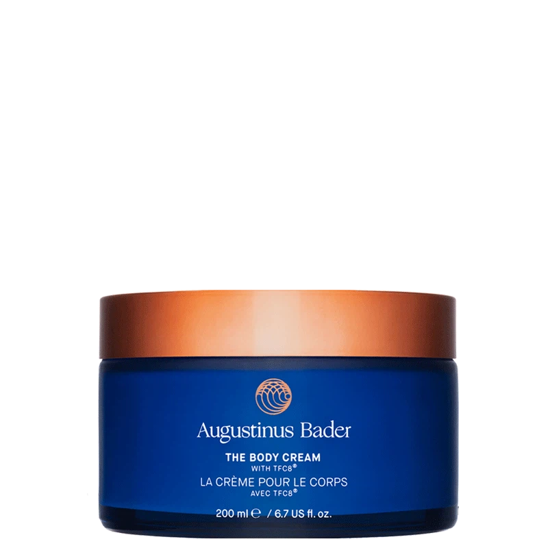 Blue jar of Augustinus Bader body cream with a copper lid on a white background