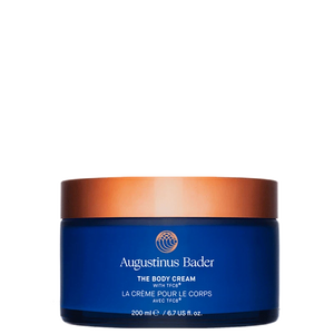 Blue jar of Augustinus Bader body cream with a copper lid on a white background