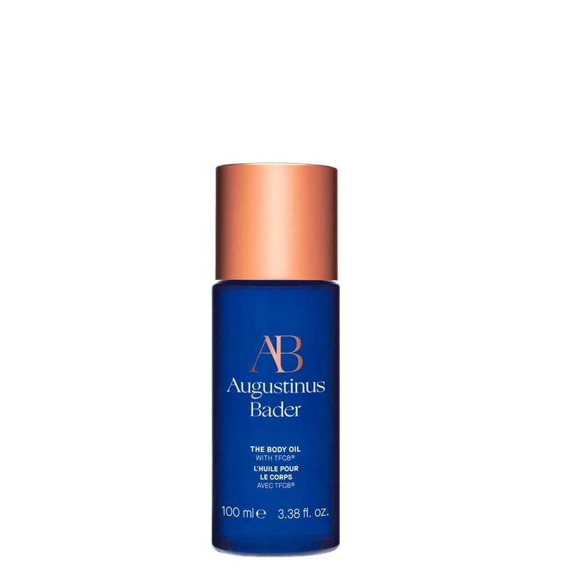 A blue bottle of the body oil with a copper cap