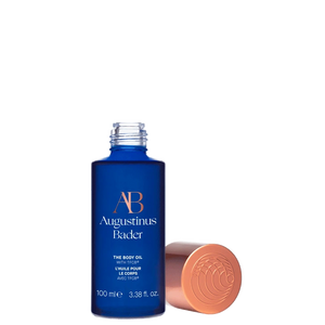 Blue bottle of Augustinus Bader body oil with a white background