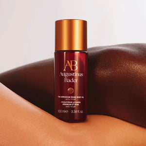 Augustinus Bader bottle of the geranium rose body oil, on two naked bodies