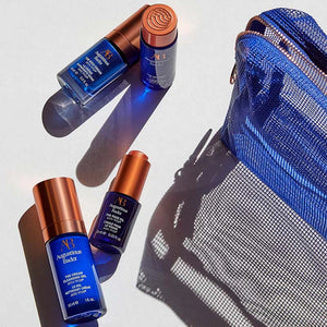 Blue and copper skincare products with a blue mesh pouch on a light gray background