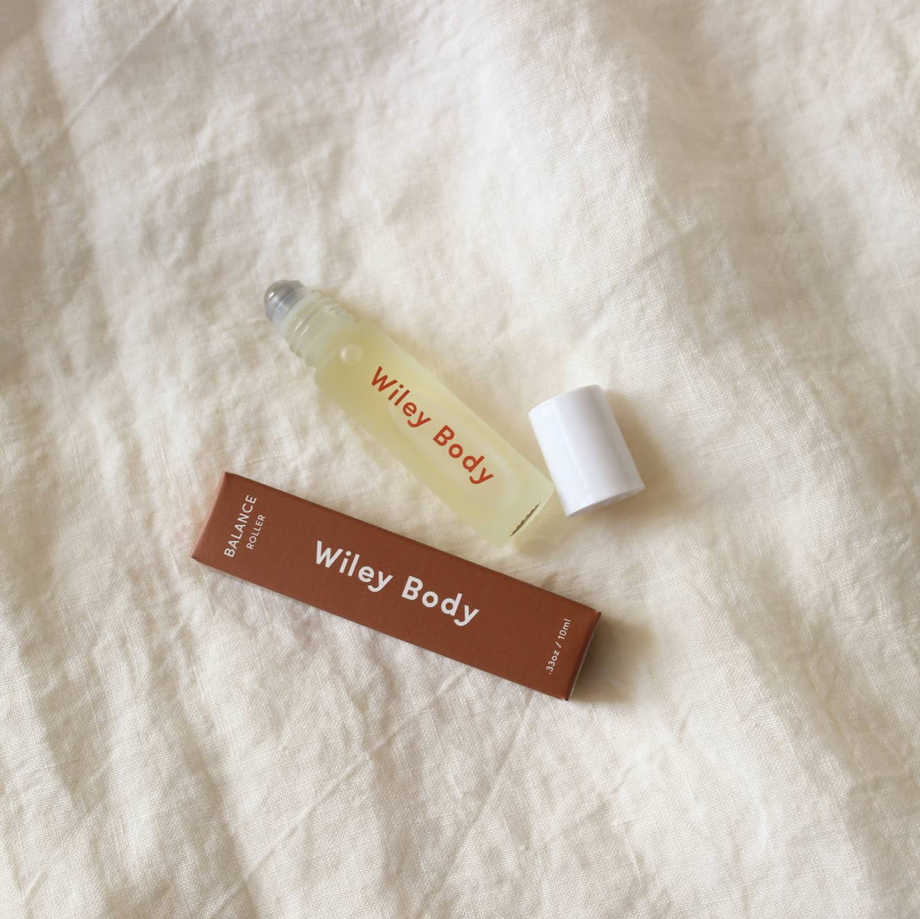 A tube of Wiley Body Balance roller with a brown box.