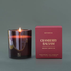 Cranberry Balsam candle and its packaging on a gray background