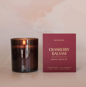 Cranberry Balsam candle and packaging on a soft pink background