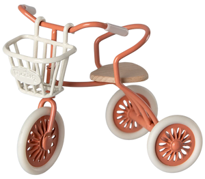 Small tricycle with a basket on a white background
