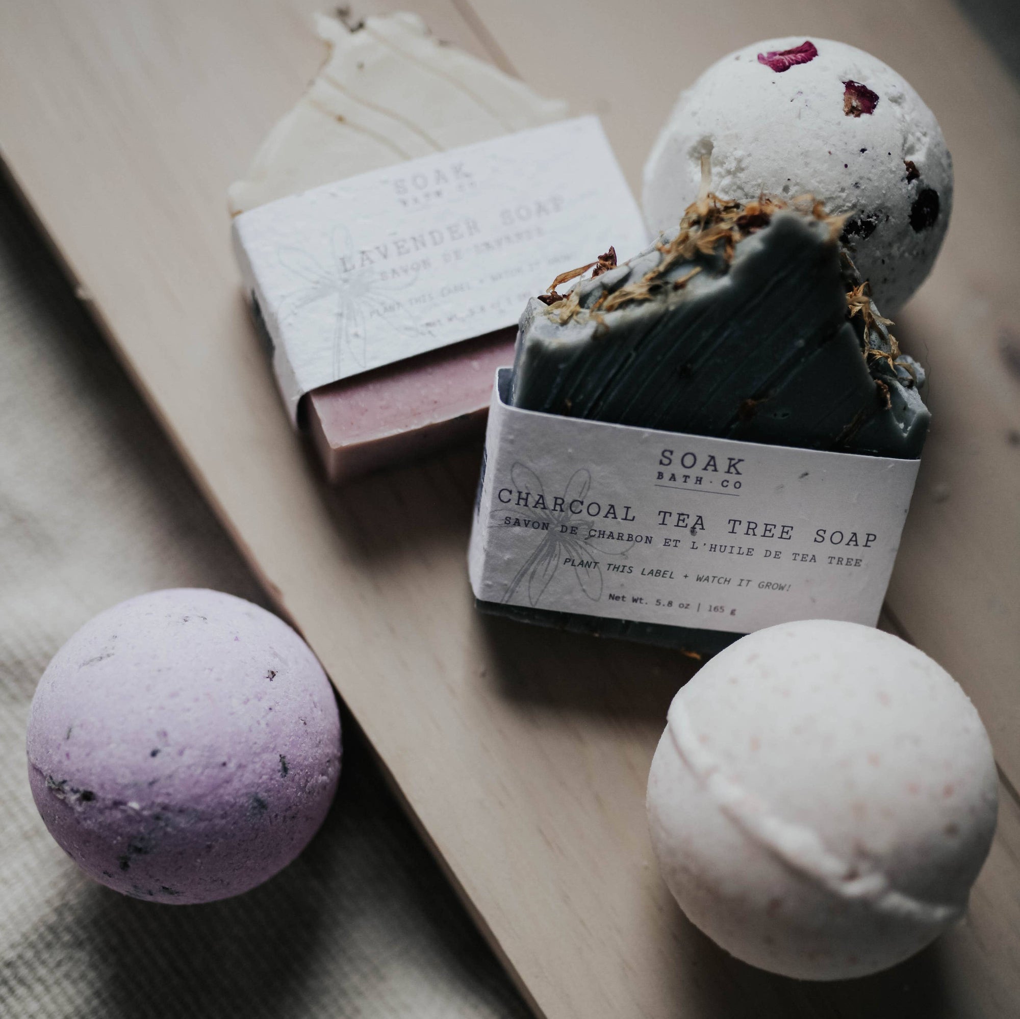 A group of soak products, including three bath bombs and two bars of soap