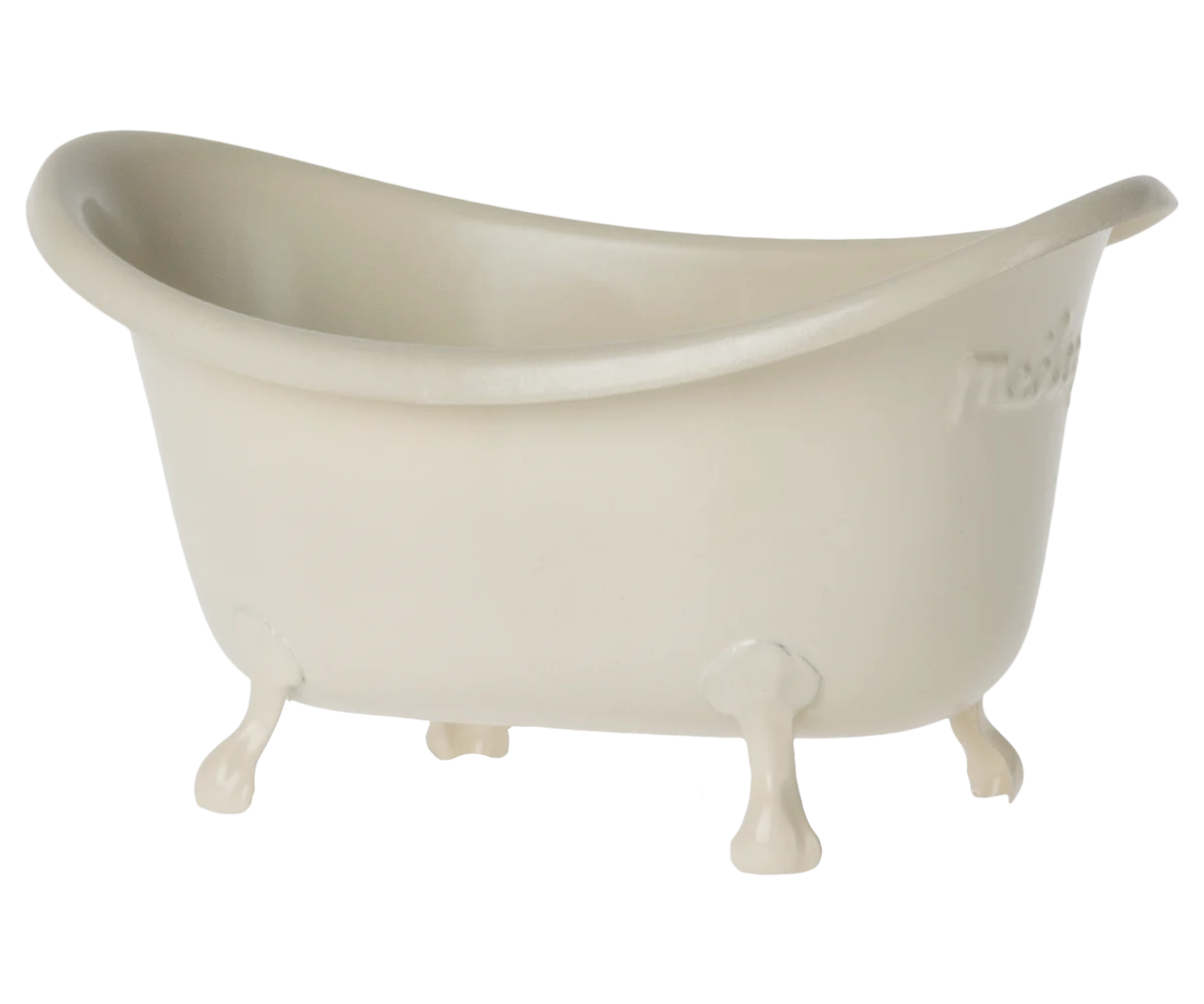 A small, white, metal mouse bathtub with four legs designed for toy mice.