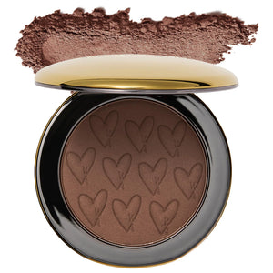 Compact brown powder with heart patterns on a white background
