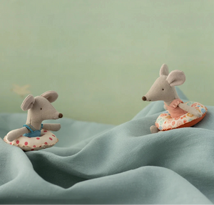 Two plush mouse toys with life vests on a textured surface with a light green background